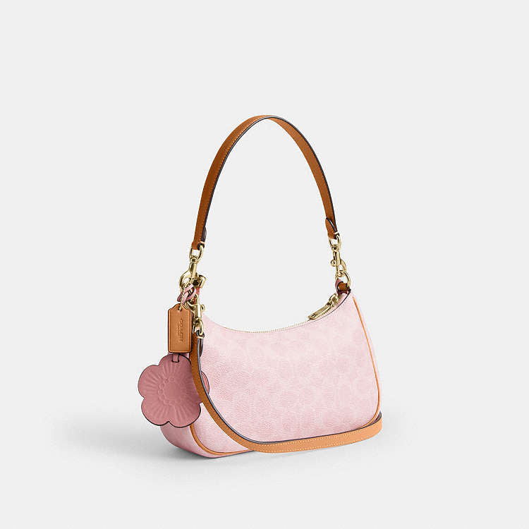 Teri Shoulder Bag
In Signature Canvas With Charm