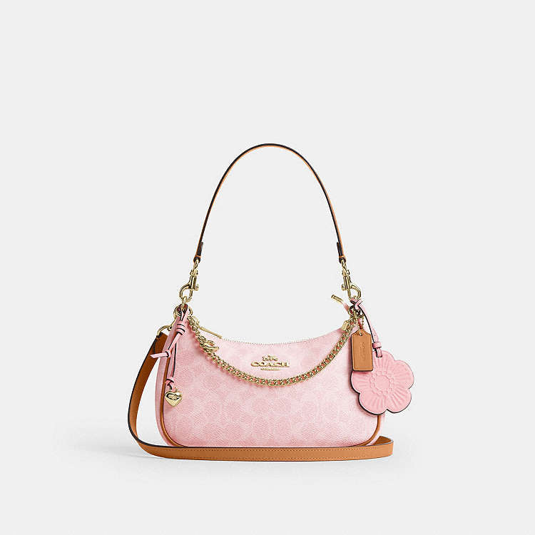 Teri Shoulder Bag
In Signature Canvas With Charm