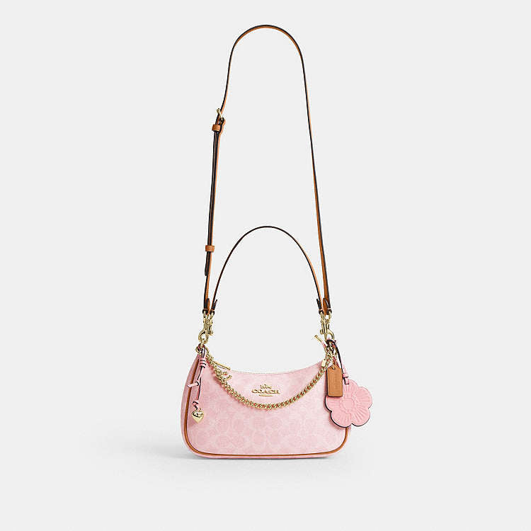 Teri Shoulder Bag
In Signature Canvas With Charm